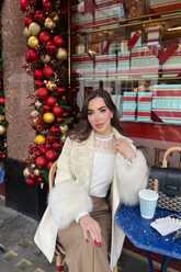 a lady in a white lace patchwork top and a white outerwear